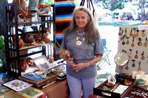 a woman standing with assorted native american merchandise