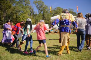 Dancers invite schoolchildren to join a dance at the Moundville Native American Festival.
